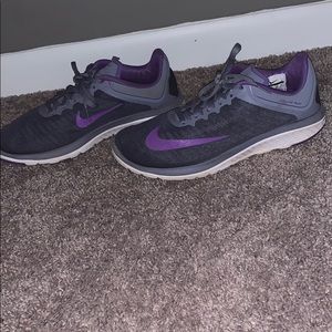 Purple and gray Nike running shoes